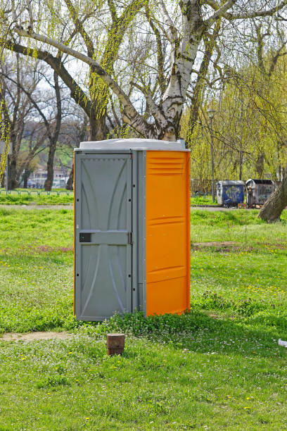 porta potty in the middle of the field